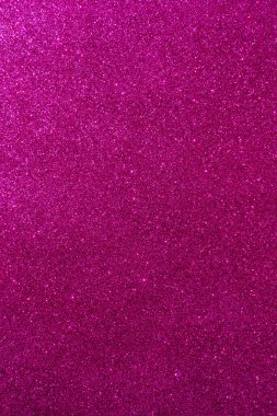 Işıltılı bir arka plan. Arkaplanda simler var. Parlak desenli yüzey. Dikey görüntü. Koyu pembe. Yumuşak ışık