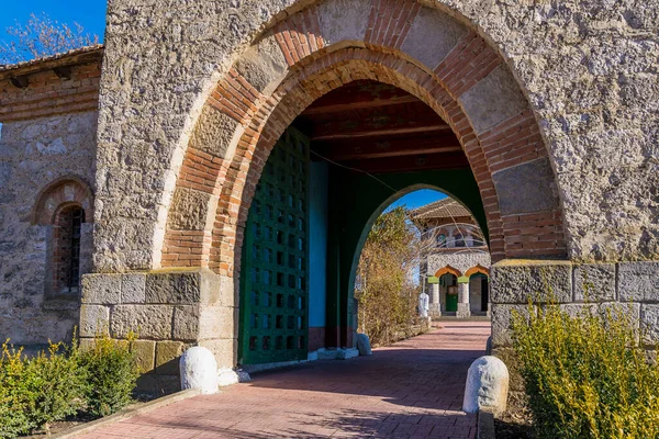 Stone arch at the entrance to the old stone church. Background with selective focus and copy space for text. Classic vintage architecture