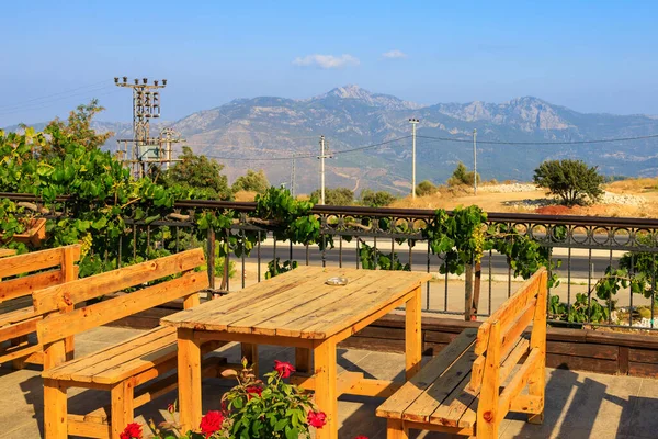 Wooden tables on the terrace of a restaurant in the mountains with a beautiful view. Popular places among tourists. Southern coastal Taurus Mountains in Turkey