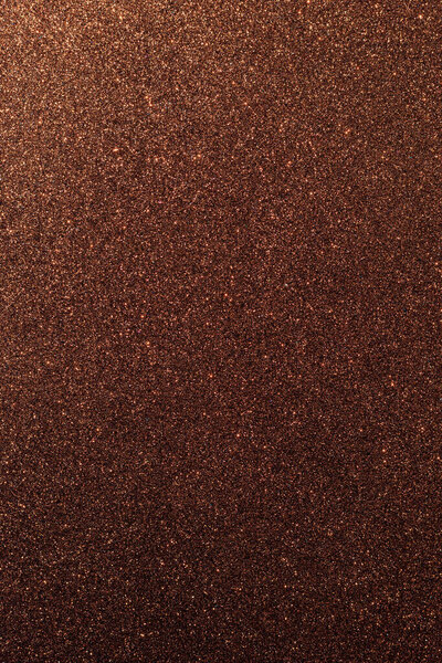 Background with sparkles. Backdrop with glitter. Shiny textured surface. Vertical image. Very dark red. Soft light