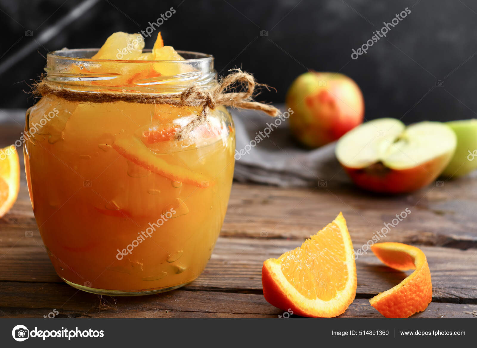 Apple jam in a transparent glass jar. Jam from apples and orange on a