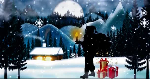 At night, snowfalls in the winter near the cottage Santa Claus and he has a candle burning in his hand. And there are gifts nearby.