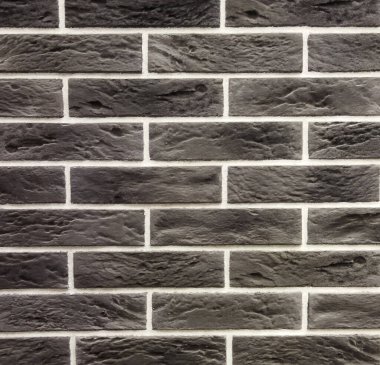 Yatay tuğla işçiliği koyu gri renktedir. Tuğla desenli siyah arkaplan.