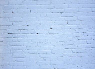 Eski, düzensiz, tuğla bir duvar. Tuğla rengi mavi..