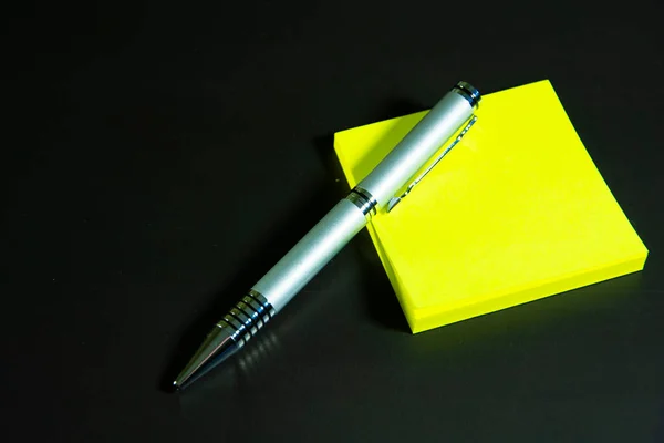 Yellow Stickers Silver Ballpoint Pen Lie Black Matte Surface Stationery — Stockfoto