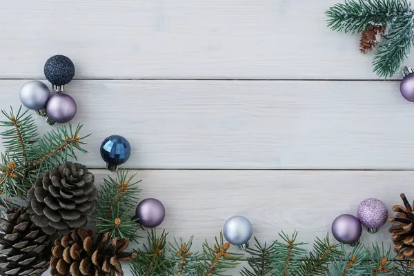 Draufsicht Auf Grüne Tannenzweige Und Zapfen Weihnachtskugeln Auf Weißem Holzbretthintergrund lizenzfreie Stockbilder