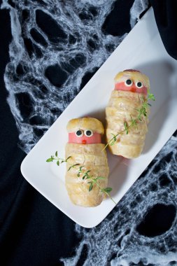Halloween treat sausage in the dough clipart