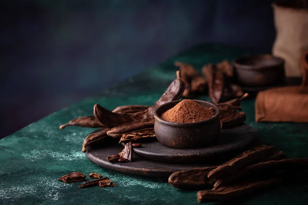 Carob-peulen, poeder en melasse of stroop — Stockfoto