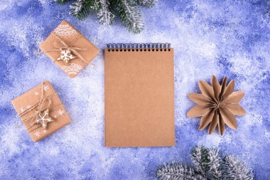 Christmas composition with empty craft notebook. New year resolution or to do list concept