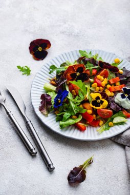 Vegetable fresh vegan salad with edible flowers