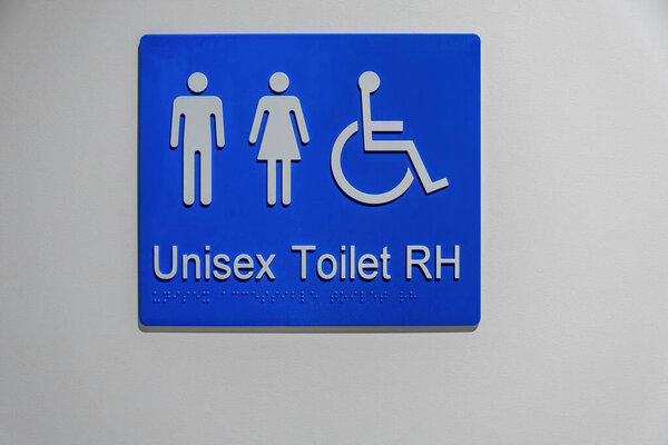 Unisex Disabled Toilet Sign White Wall Braille Writing Stock Photo