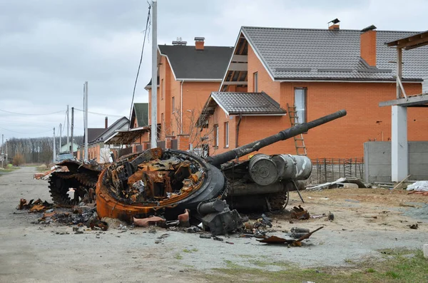 Dmytrivka village, Kyiv region, Ukraine - April 13, 2022: Destroyed Russian tank following the Ukrainian forces counter-attacks. War of Russia against Ukraine.