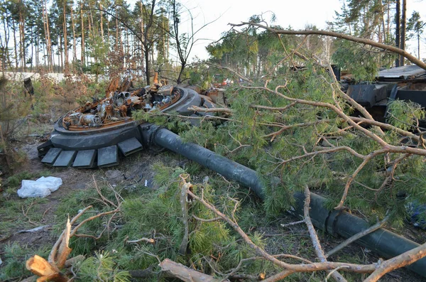 Dmytrivka village, Kyiv region, Ukraine - April 14, 2022: Destroyed Russian tank following the Ukrainian forces counter-attacks. War of Russia against Ukraine.