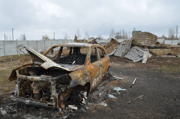 Myla köyü, Kyiv bölgesi, Ukrayna - Nisan 03, 2022: Bir tank bombardımanı sonucu araba ve özel bir ev Rus işgalciler tarafından tamamen yandı.