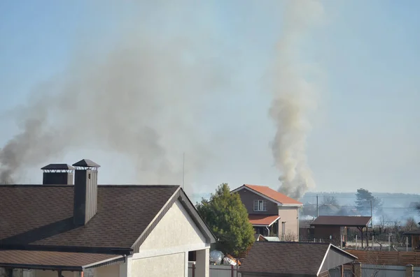 Myla village, Kyiv region, Ukraine - March 25, 2022: Private houses is on fire as a result of shelling by russian invaders during active hostilities in Kyiv region.