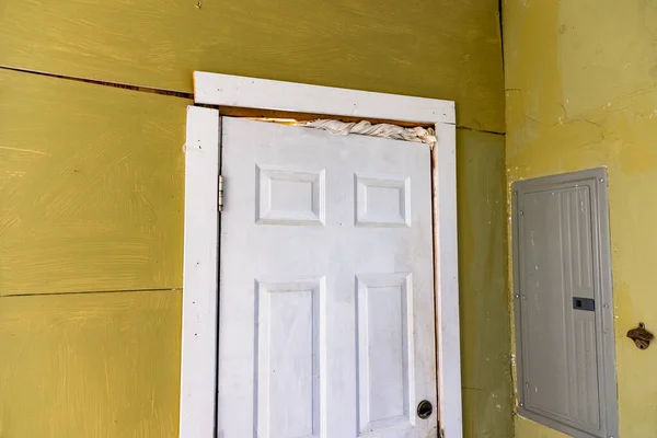 Damaged door frame and cracked walls on house with foundation problems