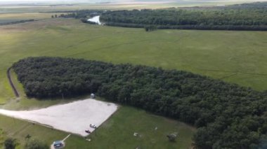 flying over river and forest and parking lot at Beaudry provincial park in Manitoba in the summer