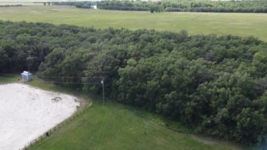flying over river and forest and parking lot at Beaudry provincial park in Manitoba in the summer