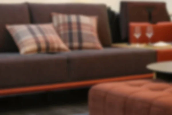 blur background of a modern living room with a sofa and lamp
