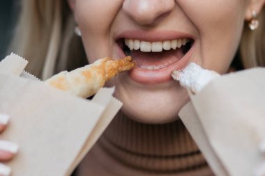 Kruvasan yiyen bir kız. Kruvasan pakette. Yiyecek..