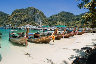 Boats along Koh Phi Phi beach in Thailand near Phuket and Krabi.