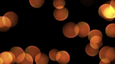 Siyah arka planda parlayan turuncu altın bokeh ışıkları. Yüksek kalite 4k görüntü