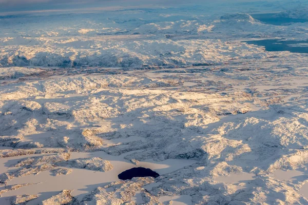 Greenlandic ice cap with frozen mountains and lake aerial view, near Nuuk, Greenland