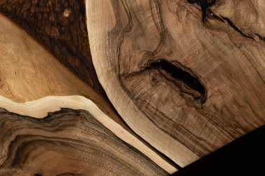 Pahalı eski mobilyalar. Masa epoksi reçineyle kaplanmış ve verniklenmiş. Lüks kaliteli ahşap işleme. Koyu arkaplanda tahta bir masa. Dikdörtgen bir ağaç tablasında altın bir epoksi nehri..