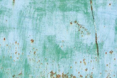 Çizik ve çatlaklarla eski paslı metal dokusu.