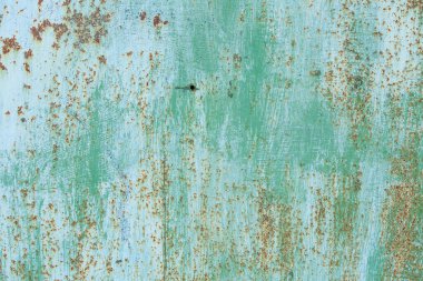 Çizik ve çatlaklarla eski paslı metal dokusu.