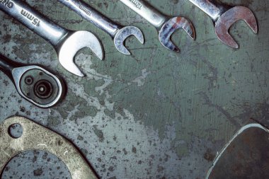 old rusty wrench and wrenches on a dark background