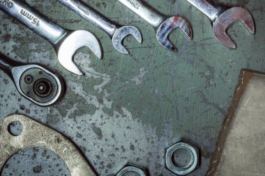 old rusty wrench and wrenches on a dark background
