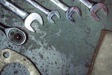 old rusty wrench and wrenches on a dark background