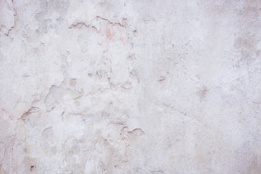 Çatlakları ve çizikleri olan eski beton duvarın dokusu arka plan olarak kullanılabilir.