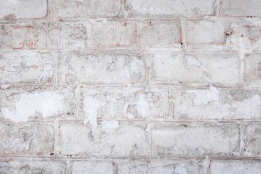 Çatlakları ve çizikleri olan tuğla duvar dokusu arka plan olarak kullanılabilir.