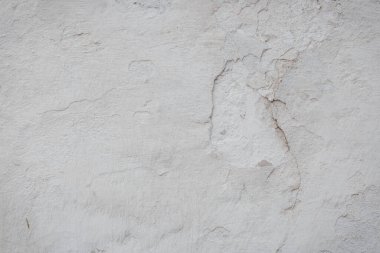 Çatlakları ve çizikleri olan eski beton duvarın dokusu arka plan olarak kullanılabilir.