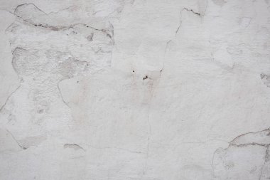 Çatlakları ve çizikleri olan eski beton duvarın dokusu arka plan olarak kullanılabilir.