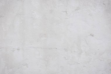 Çatlakları ve çizikleri olan eski beton duvarın dokusu arka plan olarak kullanılabilir.