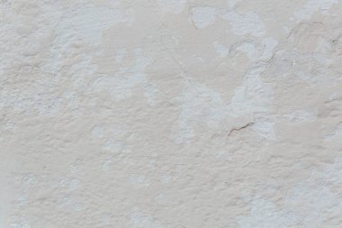 texture of old white wall with cracks and scratches which can be used as a background