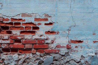 Arkaplan olarak kullanılabilecek çatlak ve çiziklerle dolu eski tuğla duvar.