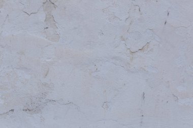 Çatlakları ve çizikleri olan eski beton duvarın dokusu arka plan olarak kullanılabilir.