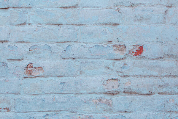 Old brick wall with cracks and scratches which can be used as a background