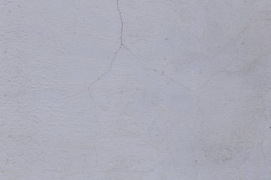 Çatlakları ve çizikleri olan eski beton duvarın dokusu arka plan olarak kullanılabilir.