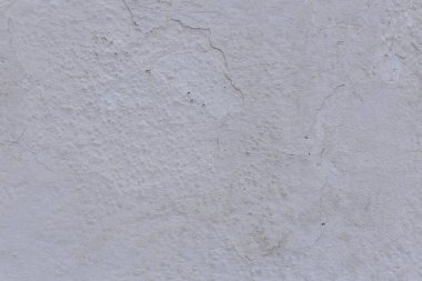 Çatlakları ve çizikleri olan eski beton duvarın dokusu arka plan olarak kullanılabilir.