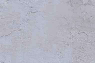 Çatlakları ve çizikleri olan eski beton duvarın dokusu arka plan olarak kullanılabilir.