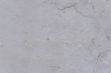 Çatlakları ve çizikleri olan eski beton duvarın dokusu arka plan olarak kullanılabilir.