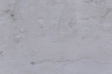 Çatlakları ve çizikleri olan eski beton duvarın dokusu arka plan olarak kullanılabilir.