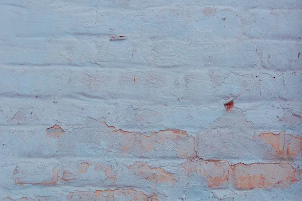 texture of a brick wall with cracks and scratches which can be used as a background