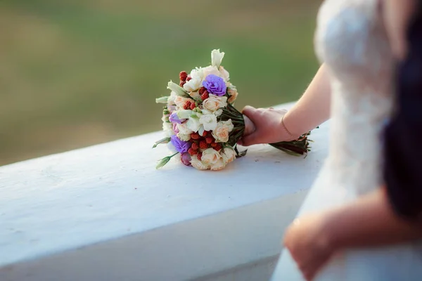 Wedding bouquet in the hands of the bride at the ceremony.