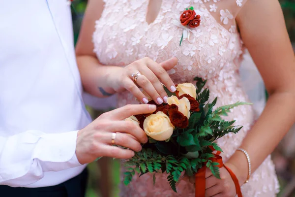 Wedding bouquet in the hands of the bride at the ceremony.